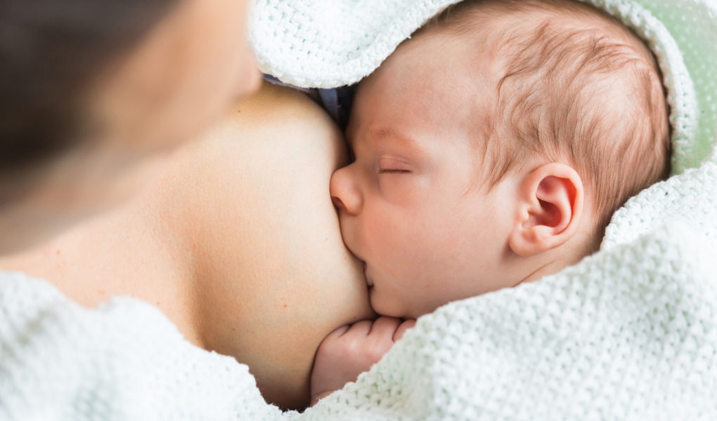 A baby is breastfeeding.