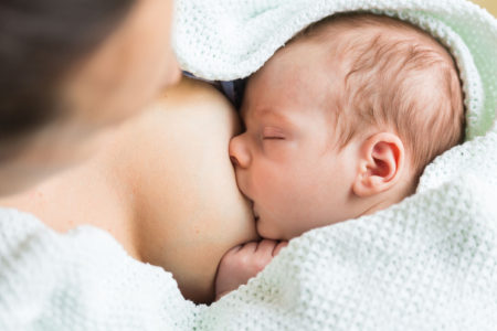 A baby is breastfeeding.
